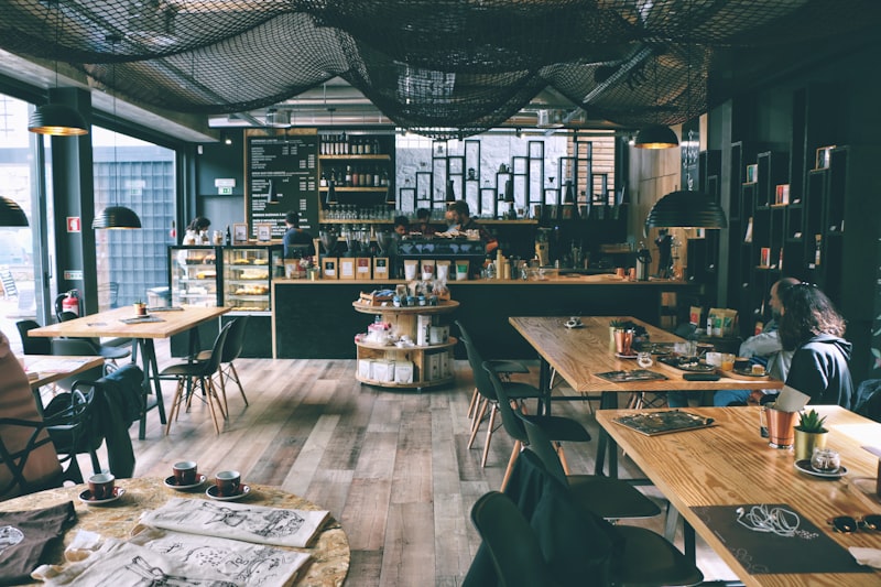 Guests sitting at wooden tables inside the cafe